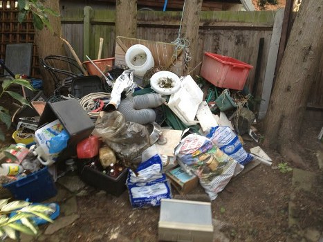 Homeowner sorting through items during garage clearance